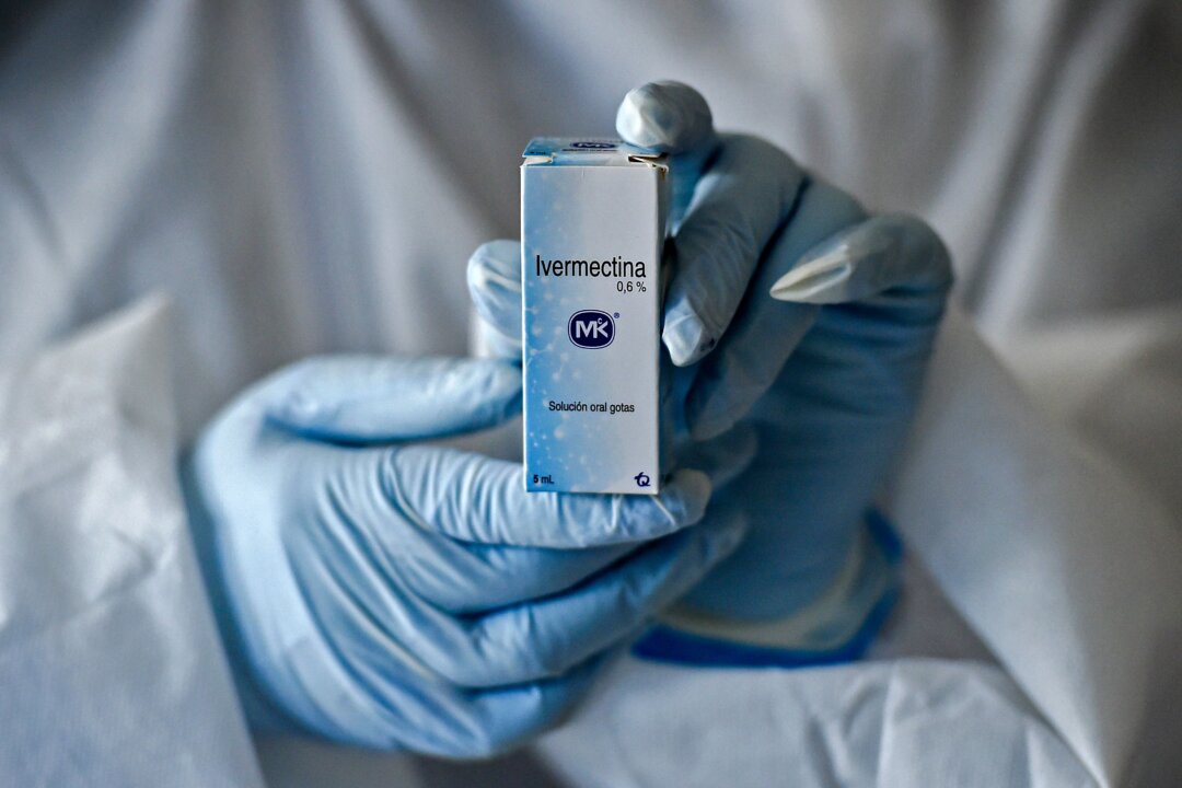 A health worker shows a box containing a bottle of ivermectin in Cali, Colombia, on July 21, 2020. (Luis Robayo/AFP via Getty Images)