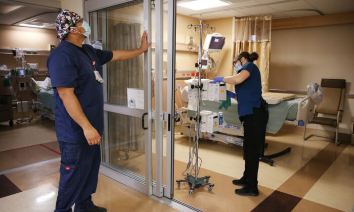 In this file photo, health care workers prepare an ICU room at Providence St. Mary Medical Center in Apple Valley, Calif., on March 30, 2021. (Mario Tama/Getty Images)