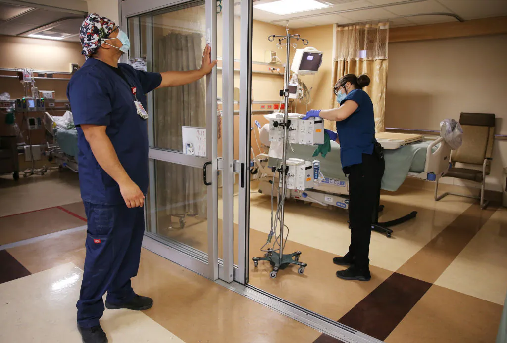 Health care workers prepare an ICU room at Providence St. Mary Medical Center in Apple Valley, Calif., on March 30, 2021. (Mario Tama/Getty Images)