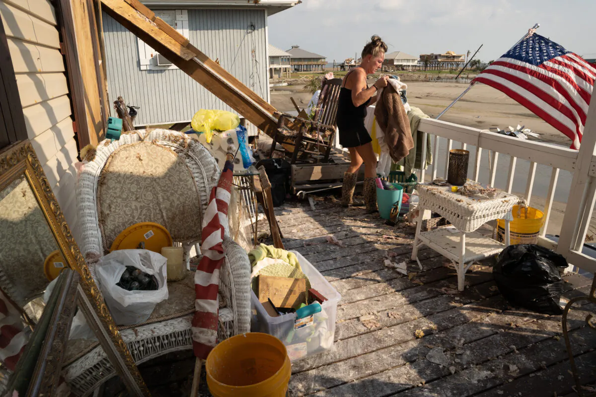 Kimberly Szeplaki cleans up her vacation house in the wake of Hurricane Ida in Grand Isle, La., on Sept. 4, 2021. (Sean Rayford/Getty Images)