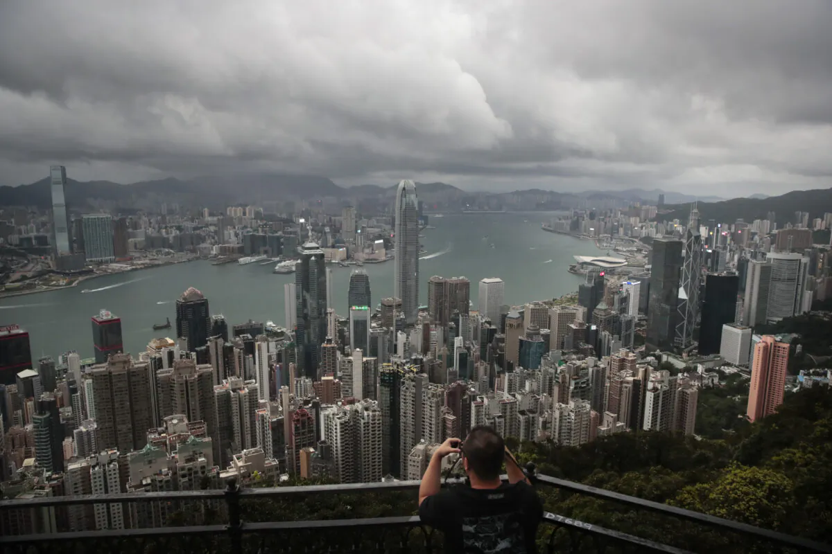 A visitor sets up his camera in the Victoria Peak area to photograph the skyline in Hong Kong, on Sept. 1, 2019. (Jae C. Hong/AP Photo)