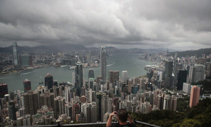 A visitor sets up his camera in the Victoria Peak area to photograph the skyline in Hong Kong, on Sept. 1, 2019. (Jae C. Hong/AP Photo)