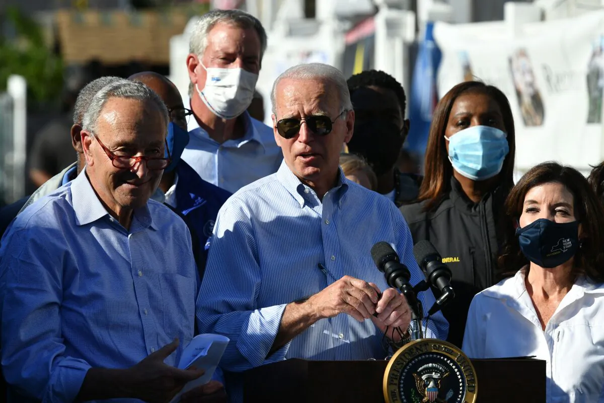 President Joe Biden speaks, flanked by US Senator Chuck Schumer (L) speaks, New York Governor Kathy Hochul (R) and New York Mayor Bill de Blasio (2nd L), during a tour of a neighbourhood affected by Hurricane Ida in Queens, New York on Sept. 7, 2021. (Mandel Ngan/AFP via Getty Images)