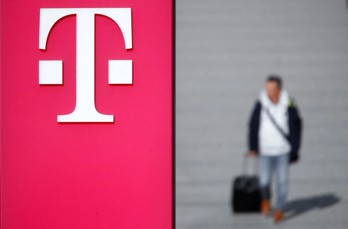 A man walks past the logo of Deutsche Telekom AG at the headquarters of German telecommunications giant in Bonn, Germany, on Febr. 19, 2019. (Wolfgang Rattay/Reuters)