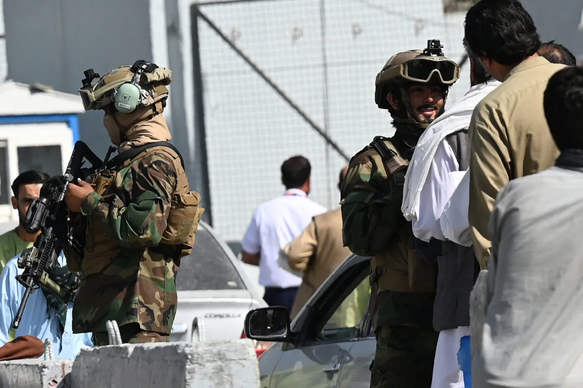 Taliban terrorists stand guard at a checkpoint as airport workers queue to enter to the Kabul International Airport in Kabul on Sept. 4, 2021. (Aamir Qureshi/AFP via Getty Images)
