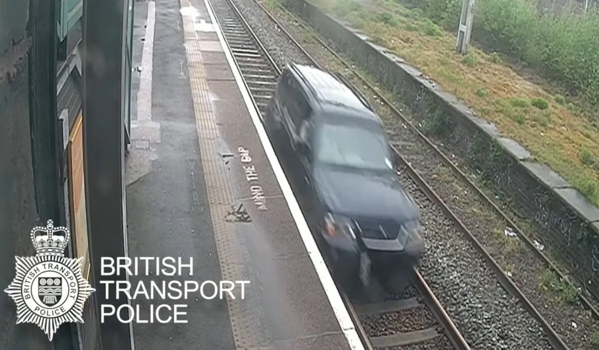 Aaron O’Halloran driving a car on railway tracks between Duddeston and Aston stations in Birmingham, UK, on May 9, 2021. (BTP/PA)