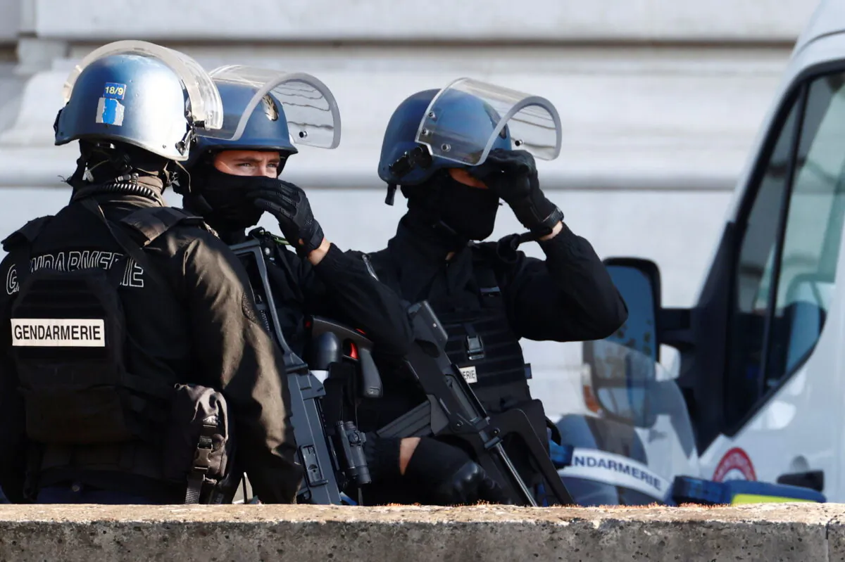 French Gendarmes secure near the Paris courthouse on the Ile de la Cite France during the arrival of a convoy believed to be carrying the defendants who stand trial over Paris' November 2015 attacks, in Paris, France, on Sept. 8, 2021. (Christian Hartmann/Reuters)