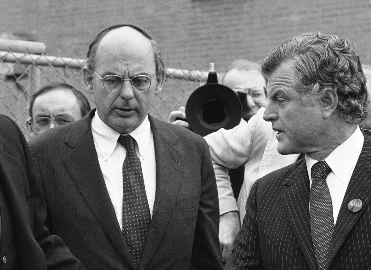 Illinois Democratic gubernatorial candidate Adlai Stevenson III (L) talks with Sen. Edward Kennedy (R) as they finish a series of appearances in Chicago on Oct. 14, 1982. (File/AP Photo)