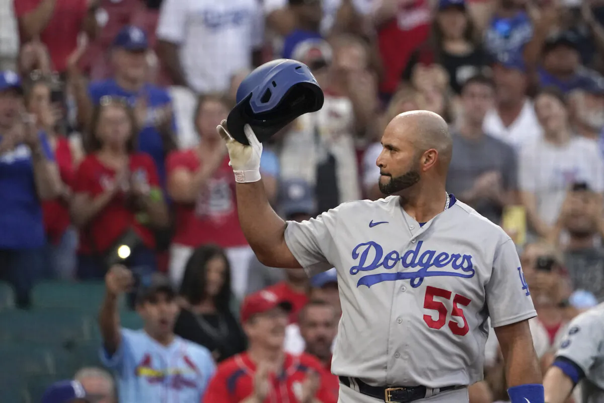 Los Angeles Dodgers' Albert Pujols tips his tap to cheering fans as he steps up to bat during the first inning of a baseball game against the St. Louis Cardinals in St. Louis on Sept. 7, 2021. (AP Photo/Jeff Roberson)