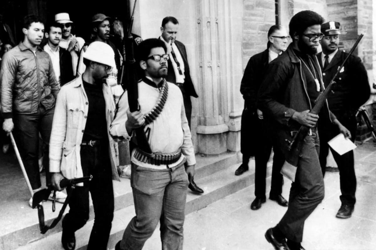 "Campus Guns", a photograph of armed black student activists leaving Willard Straight Hall at Cornell University after having occupied it for 36 hours in April 1969 in protest of racism at the university. (Public Domain)