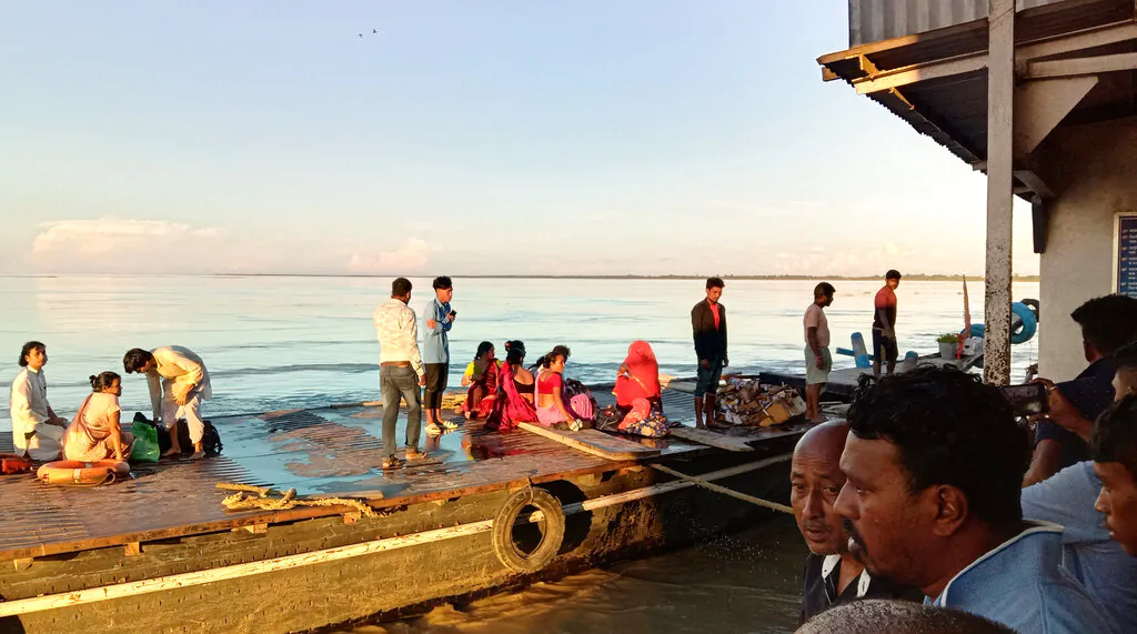 People rescued from a ferry capsize rest in the  Brahmaputra river, near Nimati Ghat, in Jorhat, about 350 kilometers from Gauhati, the capital of the northeastern Indian state of Assam, on Sept. 8, 2021. (AP Photo)