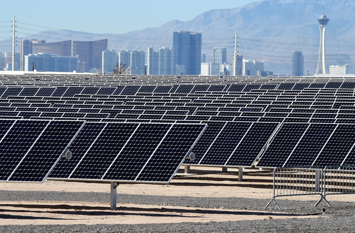 The Las Vegas Strip is shown behind solar panels during a dedication ceremony to commemorate the completion of the 102-acre, 15-megawatt Solar Array II Generating Station at Nellis Air Force Base in Las Vegas, Nevada, on Feb. 16, 2016. (Ethan Miller/Getty Images)