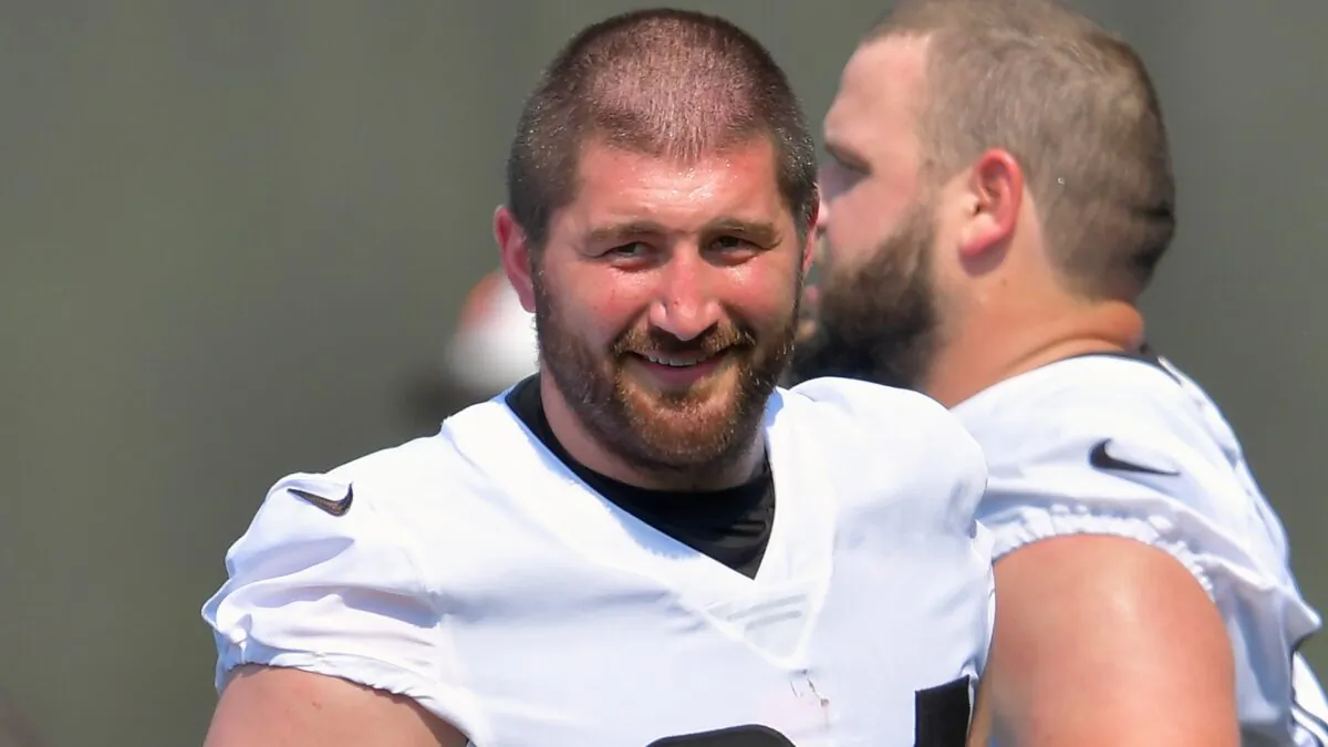 Center JC Tretter #64 of the Cleveland Browns talks with teammates during the first day of Cleveland Browns Training Camp in Berea, Ohio on July 28, 2021. (Jason Miller/Getty Images)