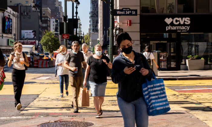 People walk on the street with masks in New York on Sept. 7, 2021. (Chung I Ho/The Epoch Times)