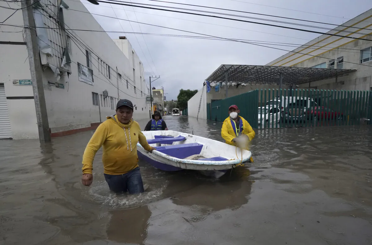 Rescuers carry inflatable boat out of a flooded hospital in Tula, Hidalgo state, Mexico, on Sept. 7, 2021. (Marco Ugarte/AP Photo)