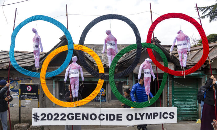 Exiled Tibetans use the Olympic Rings as a prop as they hold a street protest against the holding of 2022 Winter Olympics in Beijing, in Dharmsala, India, on  Feb. 3, 2021. (Ashwini Bhatia/AP Photo)