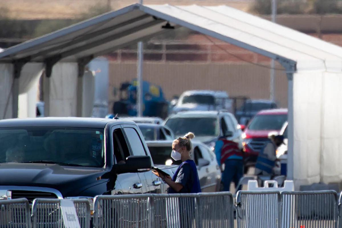 People wait after receiving a COVID-19 vaccine at State Farm Stadium in Glendale, Ariz., on Feb. 11, 2021. (Courtney Pedroza/Getty Images)
