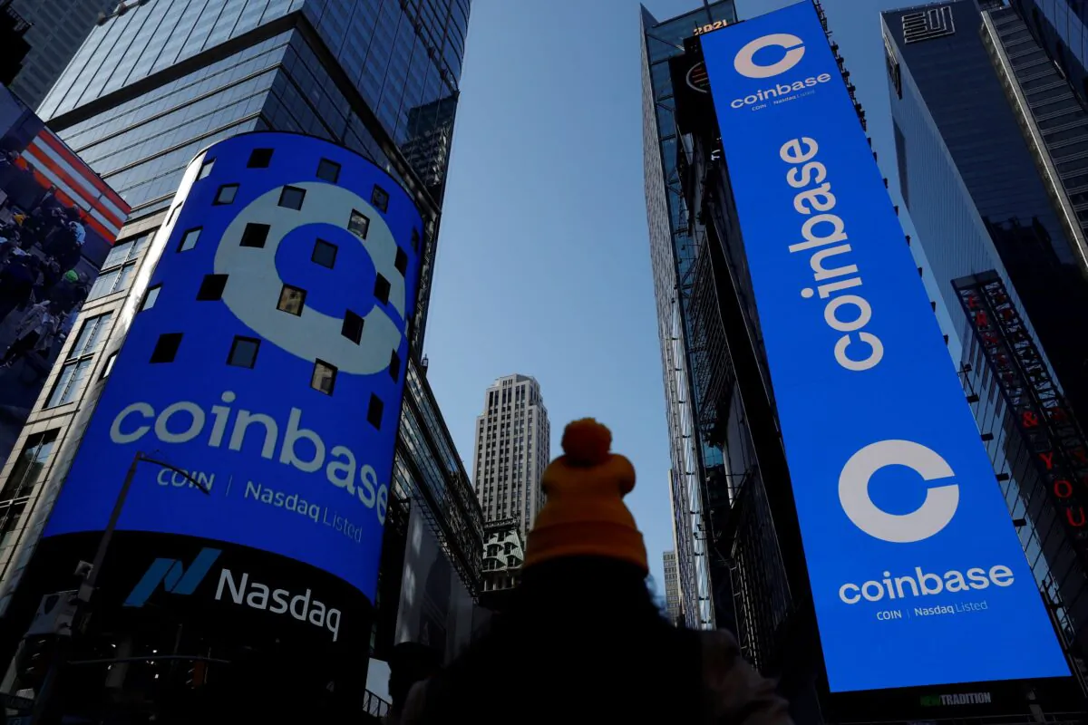 The logo for Coinbase Global Inc, the biggest U.S. cryptocurrency exchange, is displayed on the Nasdaq MarketSite jumbotron and others at Times Square in New York on April 14, 2021. (Shannon Stapleton/Reuters)