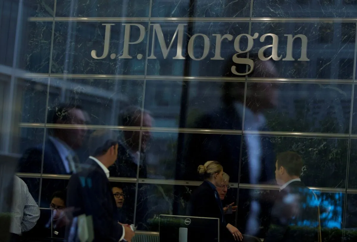 Workers are reflected in the windows of the Canary Wharf offices of JP Morgan in London on Sept.19, 2013. (Neil Hall/Reuters)