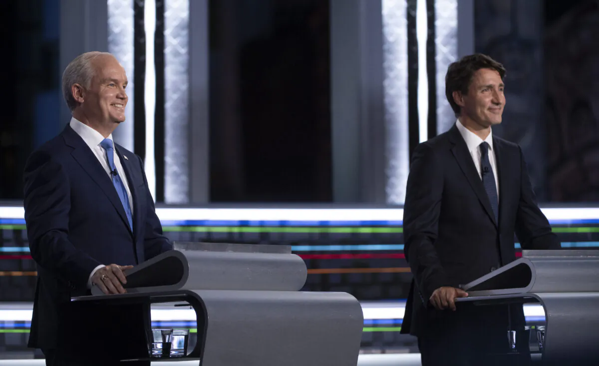 Conservative leader Erin O'Toole and Liberal leader Justin Trudeau smile during the French-language leaders debate, on Sept. 8, 2021 in Gatineau, Que. (The Canadian Press/Justin Tang)