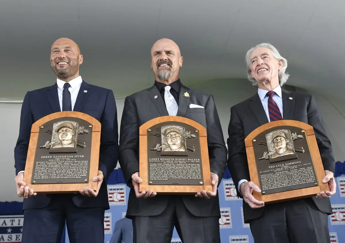 (L-R) Hall of Fame inductees Derek Jeter, Larry Walker, and Ted Simmons hold their plaques for photos after the induction ceremony at Clark Sports Center at the National Baseball Hall of Fame in Cooperstown, N.Y., on Sept. 8, 2021, (Hans Pennink/AP Photo)