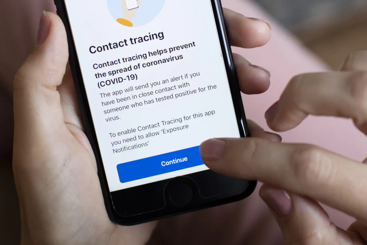 In this photo illustration, the UK government’s new test-and-trace application is displayed on a handheld device, in London on Sept. 24, 2020. (Dan Kitwood/Getty Images)