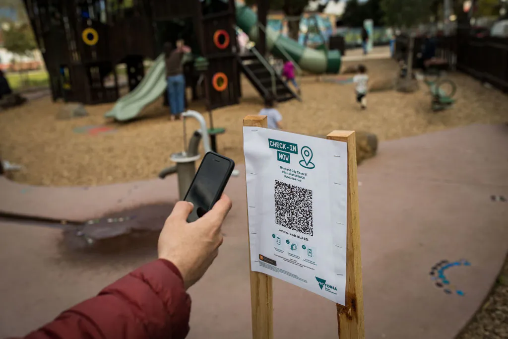 A parent uses the QR code check in at a playground in Brunswick in Melbourne, Australia, on Sept. 03, 2021. (Darrian Traynor/Getty Images)
