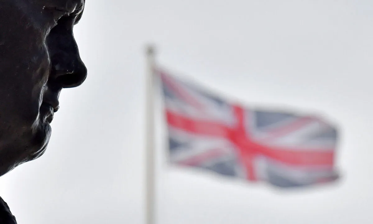 Union flags fly near a bronze statue of British war-time Prime Minister Winston Churchill, by sculptor Ivor Roberts-Jones, in Parliament Square in London, on May 11, 2021. (Justin Tallis/AFP via Getty Images)
