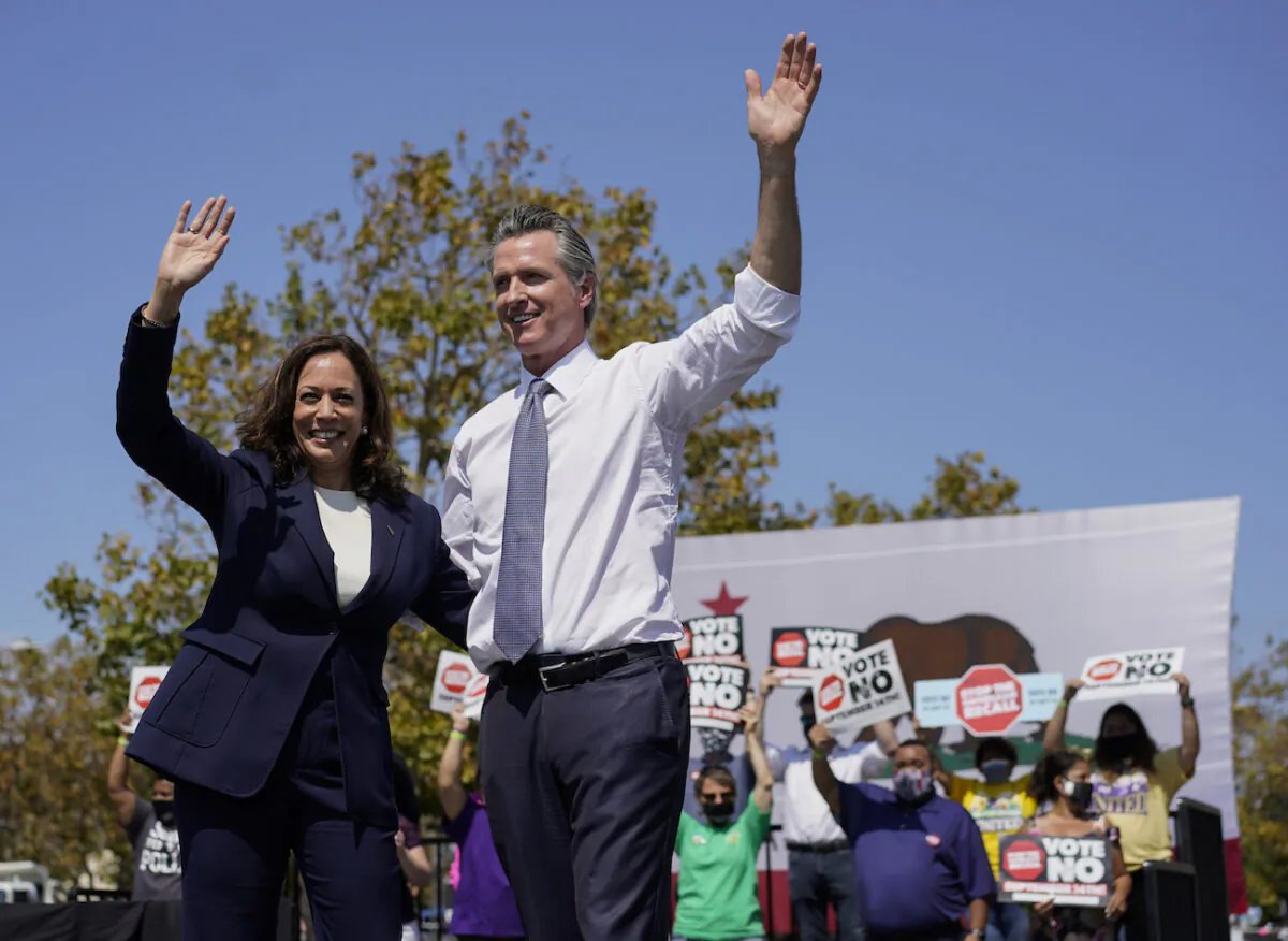 Vice President Kamala Harris stands on stage with California Gov. Gavin Newsom at the conclusion of an event at the IBEW-NECA Joint Apprenticeship Training Center in San Leandro, Calif., Sept. 8, 2021. (AP Photo/Carolyn Kaster)