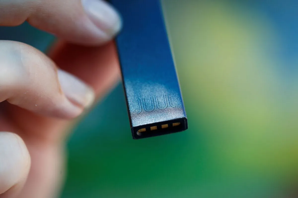 A woman holds a Juul e-cigarette in a file photo. (Ronen Zvulun/Reuters)