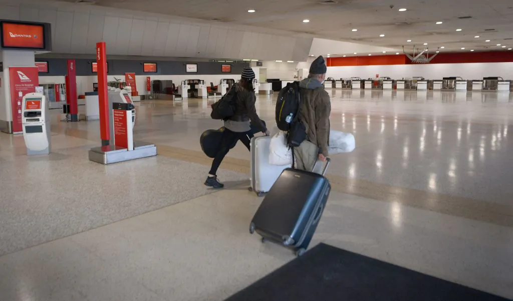 Travellers walk through a deserted Qantas terminal at Melbourne Airport in Melbourne, Australia on Aug. 26, 2021 (William West/AFP via Getty Images)