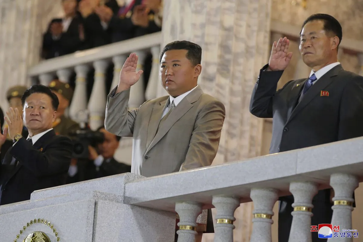 North Korean leader Kim Jong Un, center, waves from a balcony toward the assembled troops and spectators during a celebration of the nation’s 73rd anniversary at Kim Il Sung Square in Pyongyang, North Korea, on Sept. 9, 2021. (Korean Central News Agency/Korea News Service via AP)