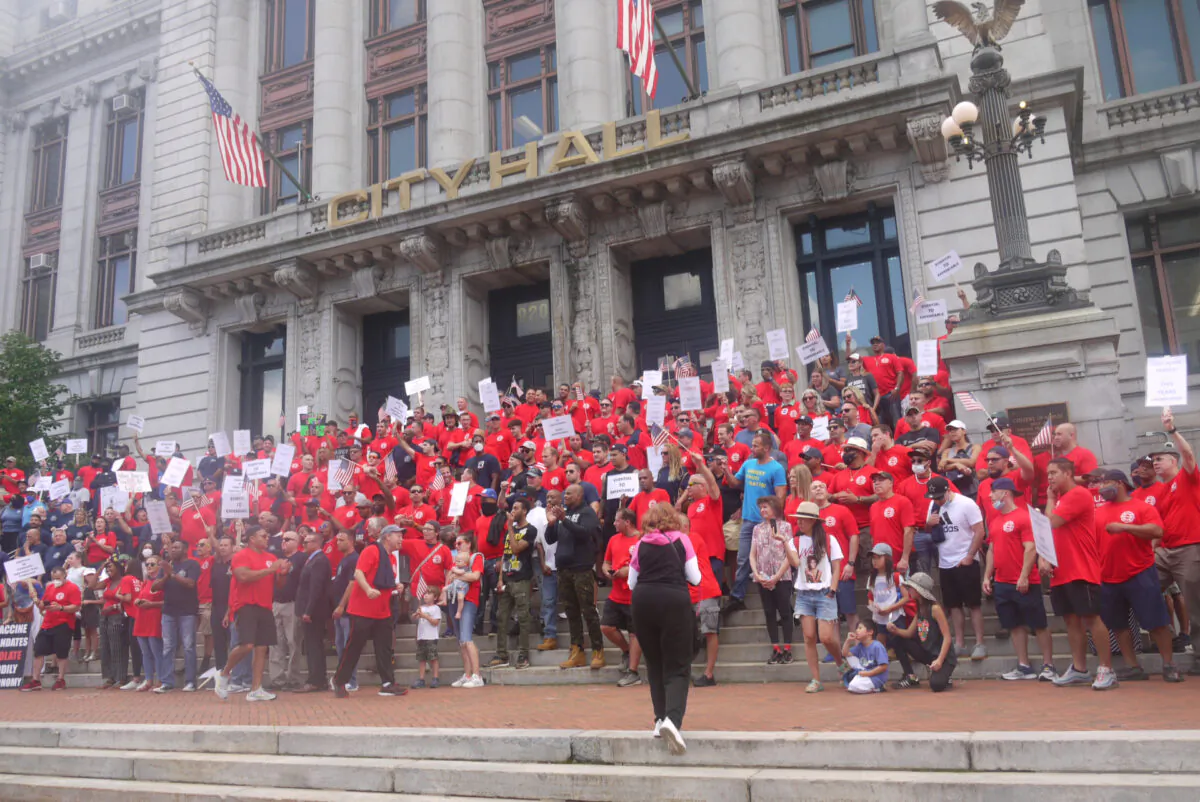 People participate in the rally outside the City Hall organized by firefighters and police unions to demand negotiations on the COVID-19 Vaccine Mandate in Newark, N.J., on Sept. 8, 2021. (Ella Kietlinska/The Epoch Times)