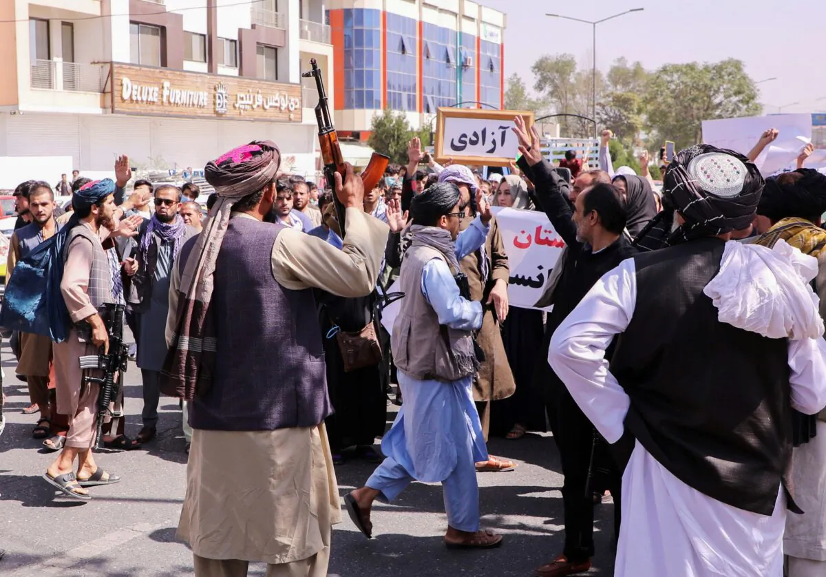 Taliban fighters try to stop protesters, as they shout slogans during an anti-Pakistan protest, near the Pakistan embassy in Kabul, Afghanistan, on Sept. 7, 2021. (Stringer/Reuters)