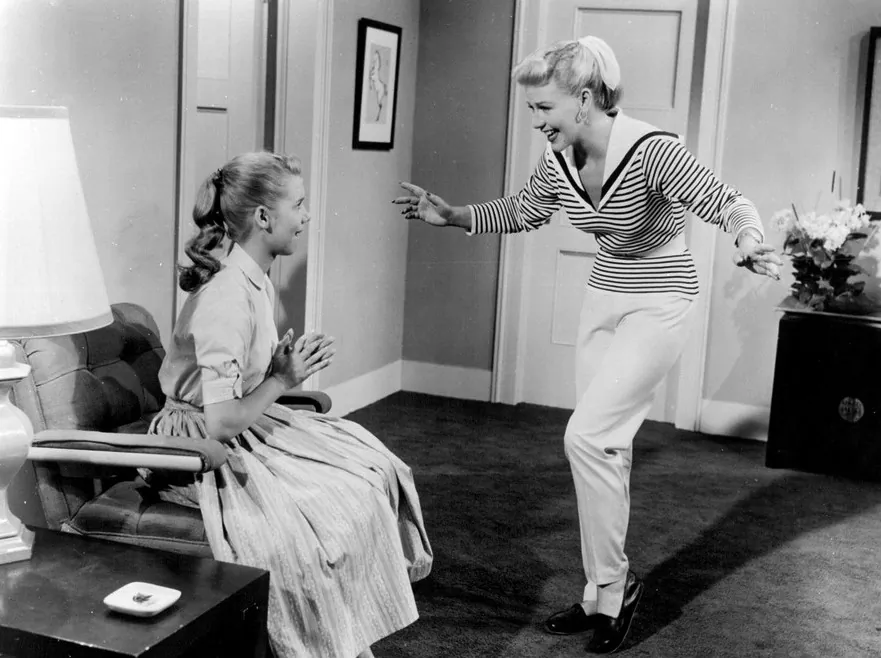 Nancy Fallon (Ginger Rogers, R) tries to win back the love of her troubled 15-year-old Dodie McGowan (Betty Lou Keim), in “Teenage Rebel.” (Public Domain)