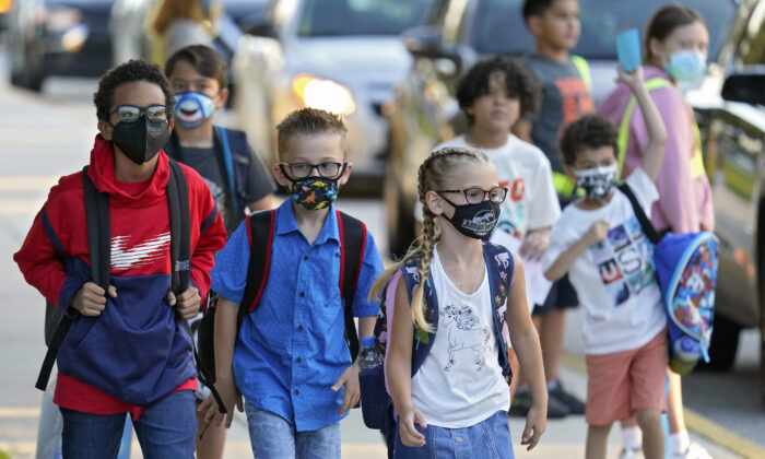 Students, some wearing protective masks, arrive for the first day of school at Sessums Elementary School in Riverview, Fla., on Aug. 10, 2021. (Chris O'Meara/AP Photo)