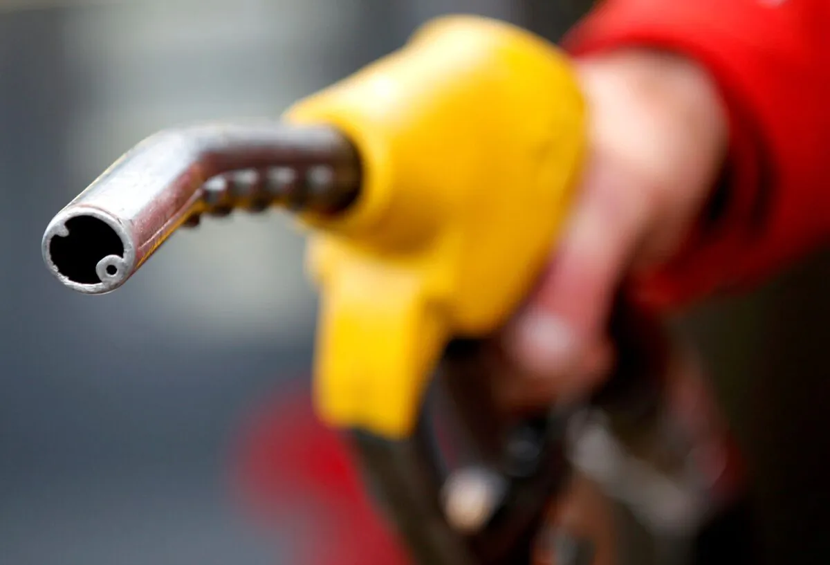 A petrol station attendant prepares to refuel a car in Rome, Italy, on Jan. 4, 2012. (Max Rossi/Reuters)