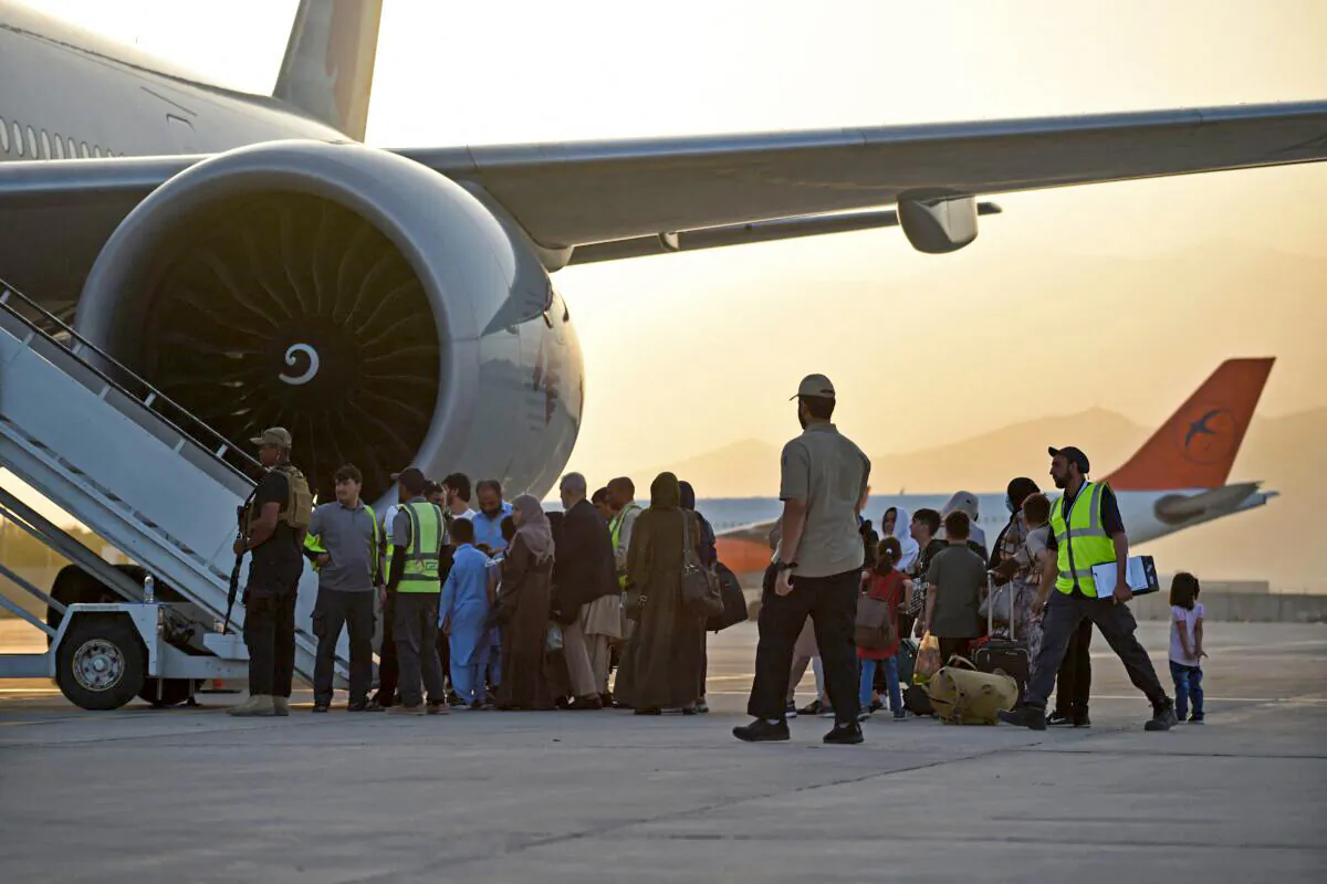 Passengers prepare to board a Qatar Airways aircraft at the airport in Kabul, Afghanistan, on Sept. 9, 2021. (Wakil Kohsar/AFP via Getty Images)