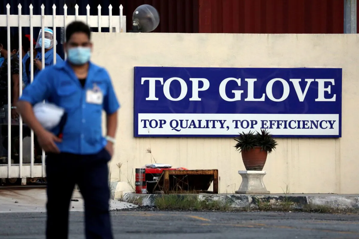 A worker leaves a Top Glove factory after his shift in Klang, Malaysia on Dec. 7, 2020. (Lim Huey Teng/Reuters)