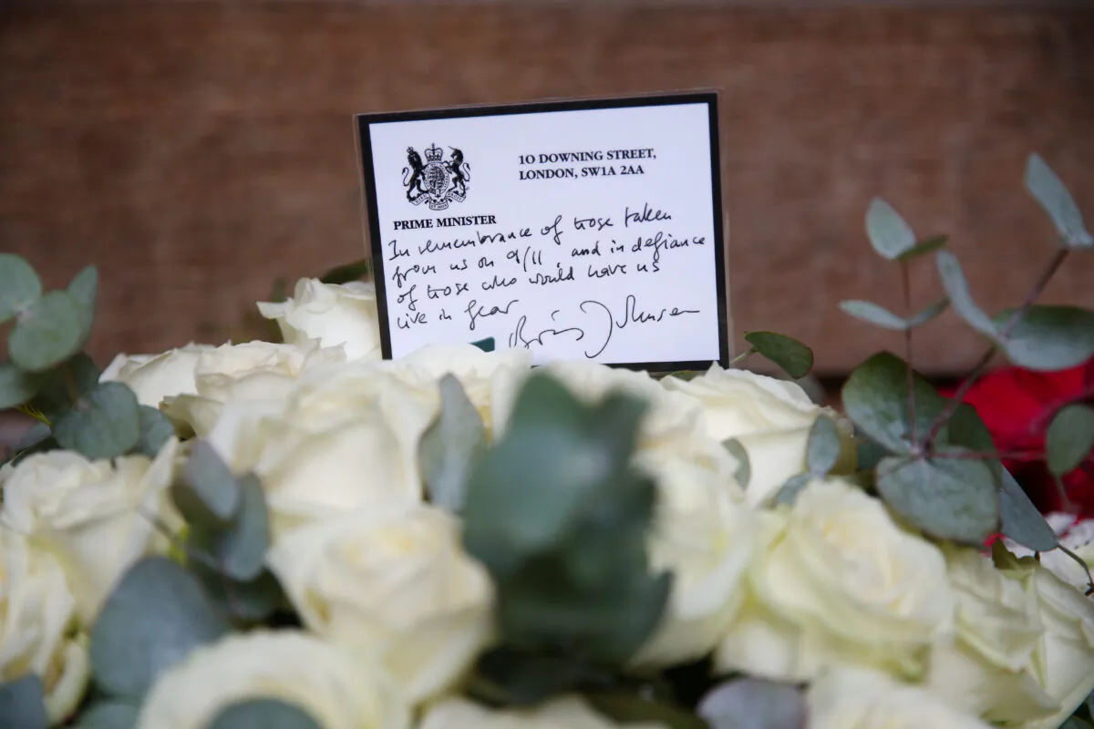 A floral tribute laid on behalf of British Prime Minister Boris Johnson at the 9/11 Memorial Garden at Grosvenor Square in London, on Sept. 11, 2021. (Hollie Adams/Getty Images)