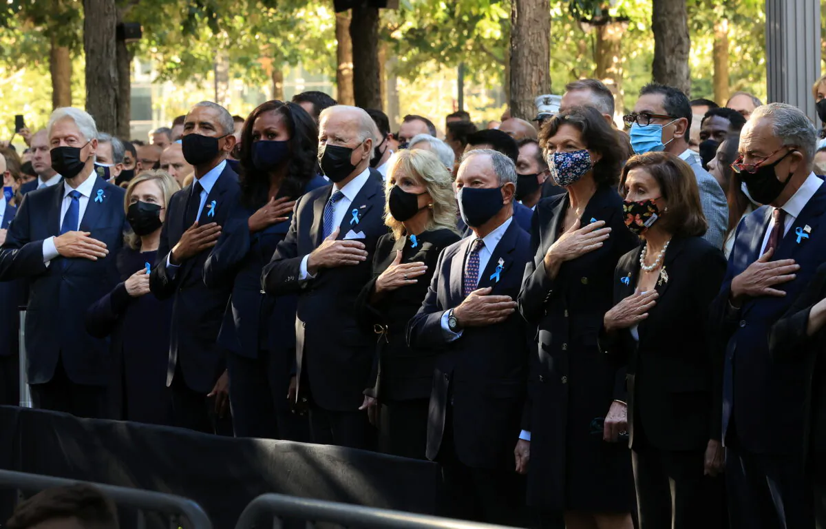 (L-R) Former President Bill Clinton, former First Lady Hillary Clinton, former President Barack Obama, former First Lady Michelle Obama, President Joe Biden, First Lady Jill Biden, former New York City Mayor Michael Bloomberg, Bloomberg's partner Diana Taylor, Speaker of the House Nancy Pelosi (D-Calif.), and Senate Minority Leader Charles Schumer (D-N.Y.) stand for the national anthem during the annual Sept. 11, 2001, commemoration ceremony at the Sept. 11 memorial in New York on Sept. 11, 2021. (Chip Somodevilla/Pool via Reuters)