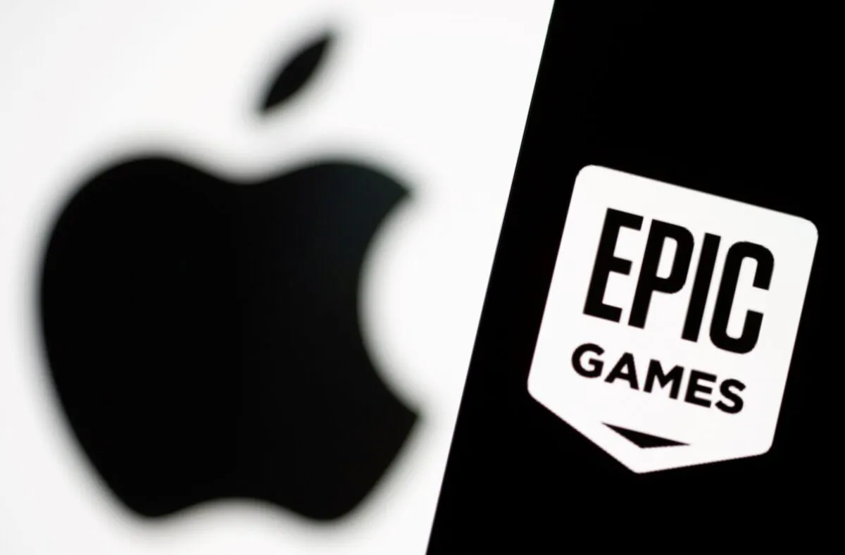 Smartphone with Epic Games logo is seen in front of Apple logo in this illustration taken, on May 2, 2021. (Dado Ruvic/Illustration/Reuters)
