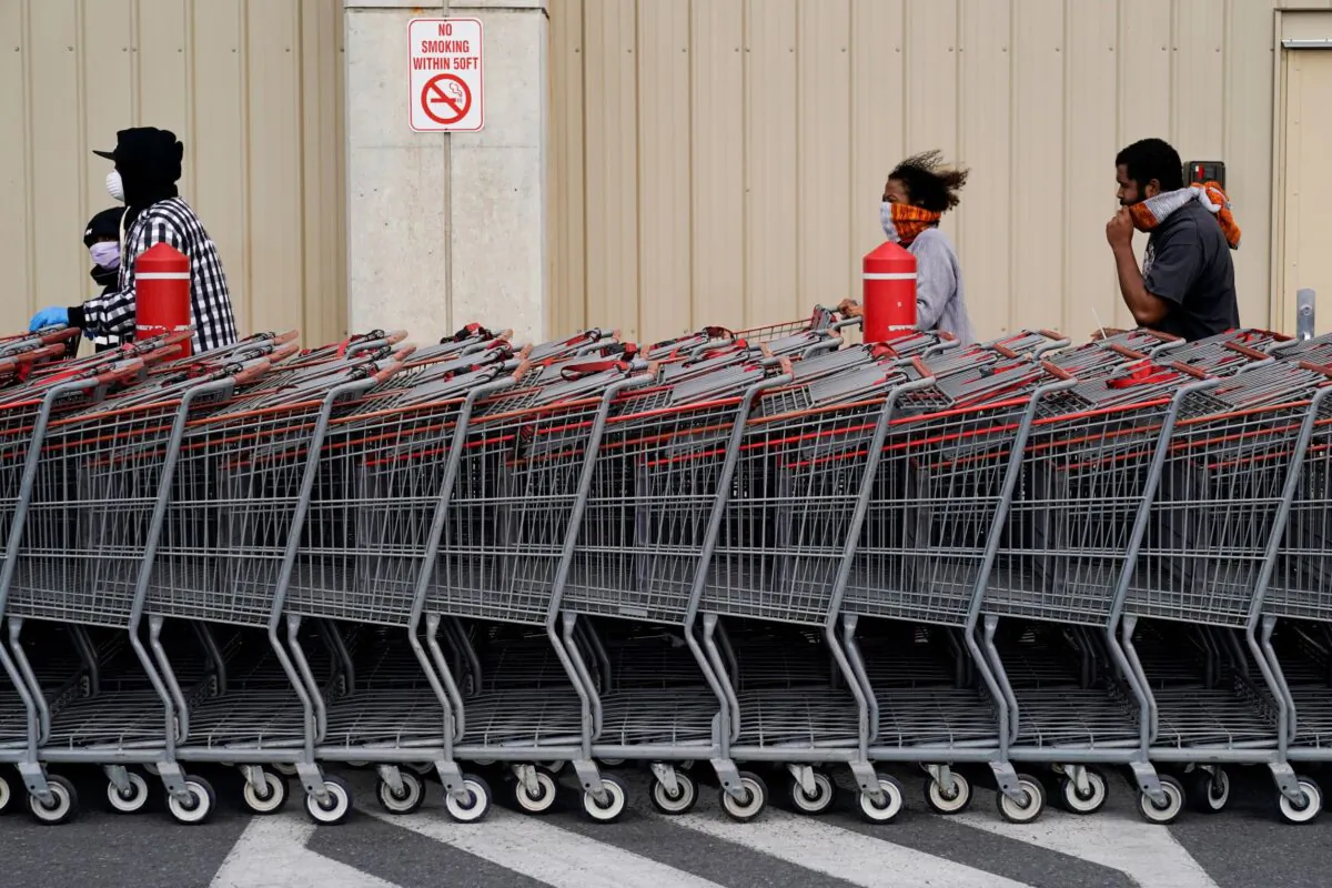 People wear masks as they wait to enter a Costco Wholesale store during the outbreak of coronavirus disease (COVID-19) in Washington on April 10, 2020. (Joshua Roberts/Reuters)