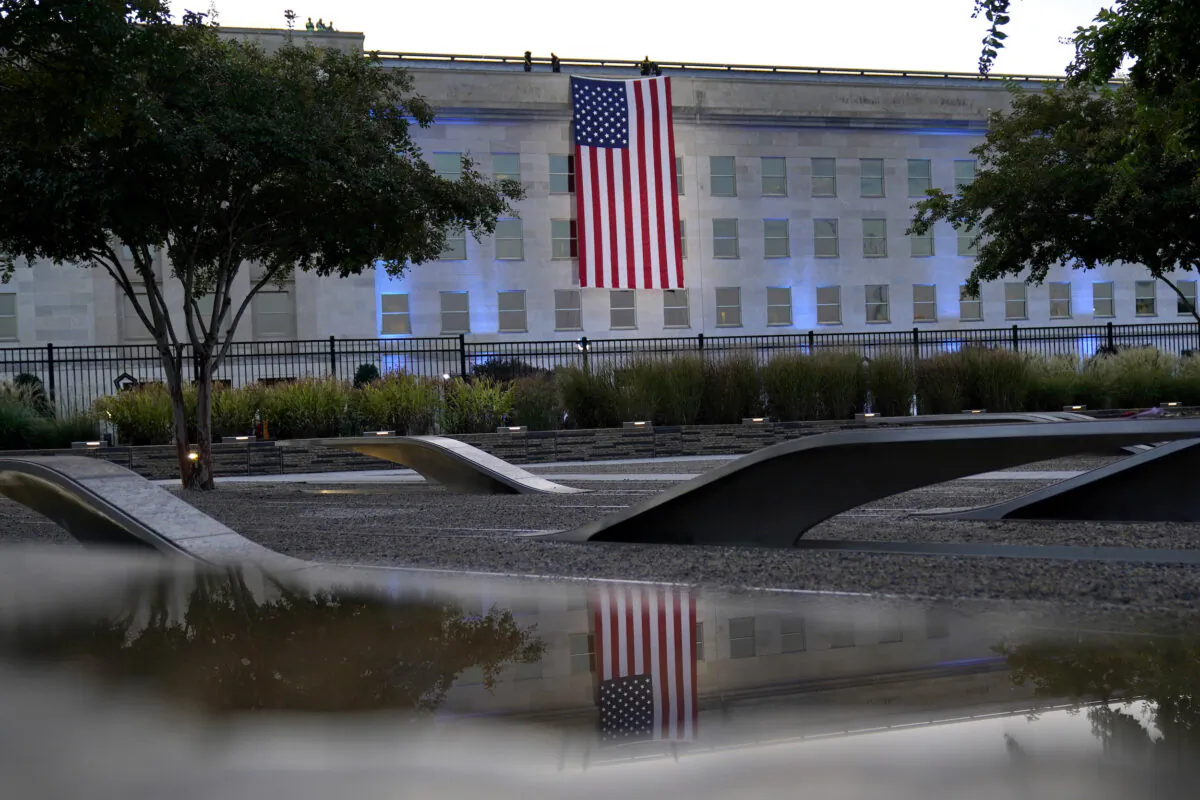 An American flag is unfurled at the Pentagon in Washington at sunrise on the morning of the 20th anniversary of the terrorist attacks on Sept. 11, 2021. (Alex Brandon/AP Photo)