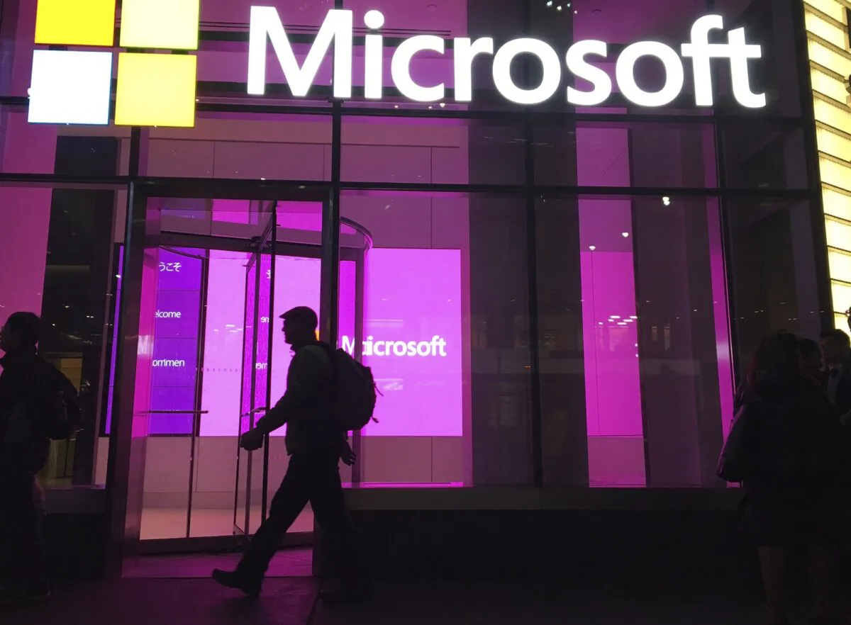 People walk near a Microsoft office in New York on Nov. 10, 2016. (Swayne B. Hall/AP Photo)