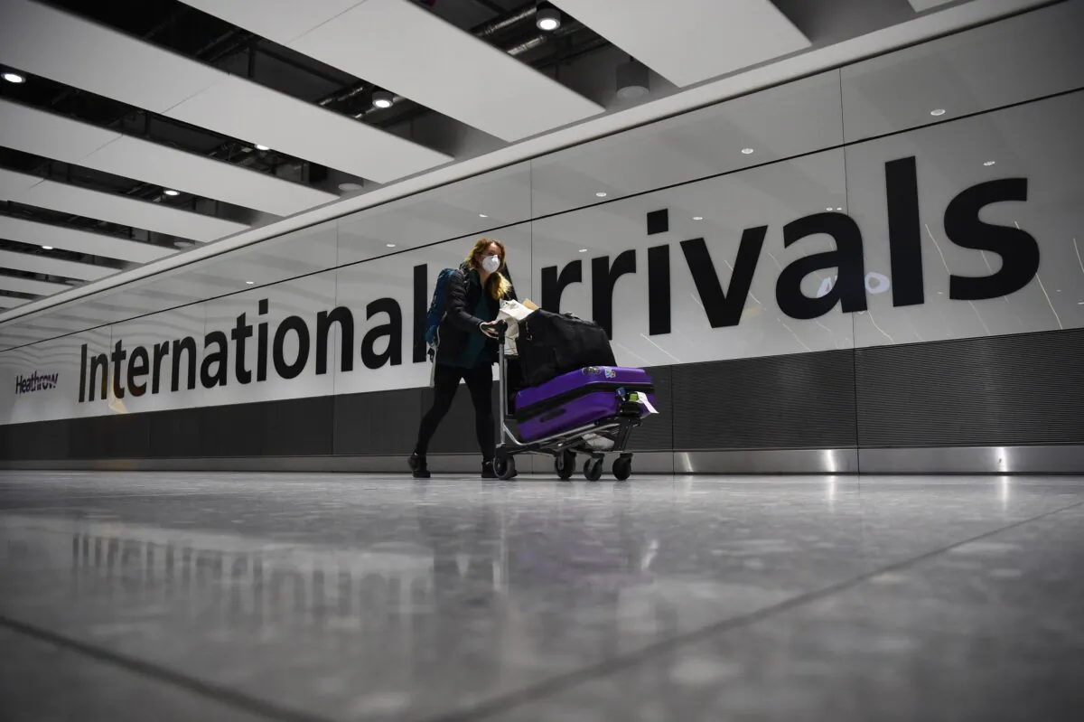 A passenger pushing luggage through the Arrival Hall of Terminal 5 at London's Heathrow Airport on Jan. 18, 2021. (Kirsty O’Connor/PA)