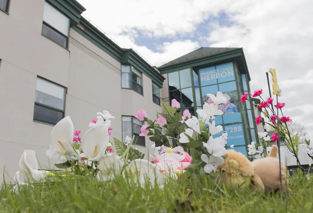 Plush toys and flowers are shown outside Residence Herron in the Montreal suburb of Dorval, May 10, 2020. (The Canadian Press/Graham Hughes)