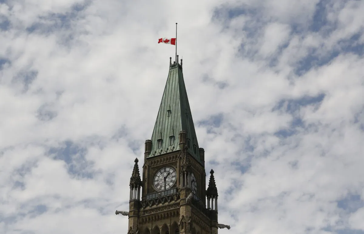 The Canadian flag on the Peace Tower on Parliament Hill flies at half-mast in recognition of the discovery of potential unmarked graves at residential schools, on Canada Day, July 1, 2021. (The Canadian Press/Patrick Doyle)