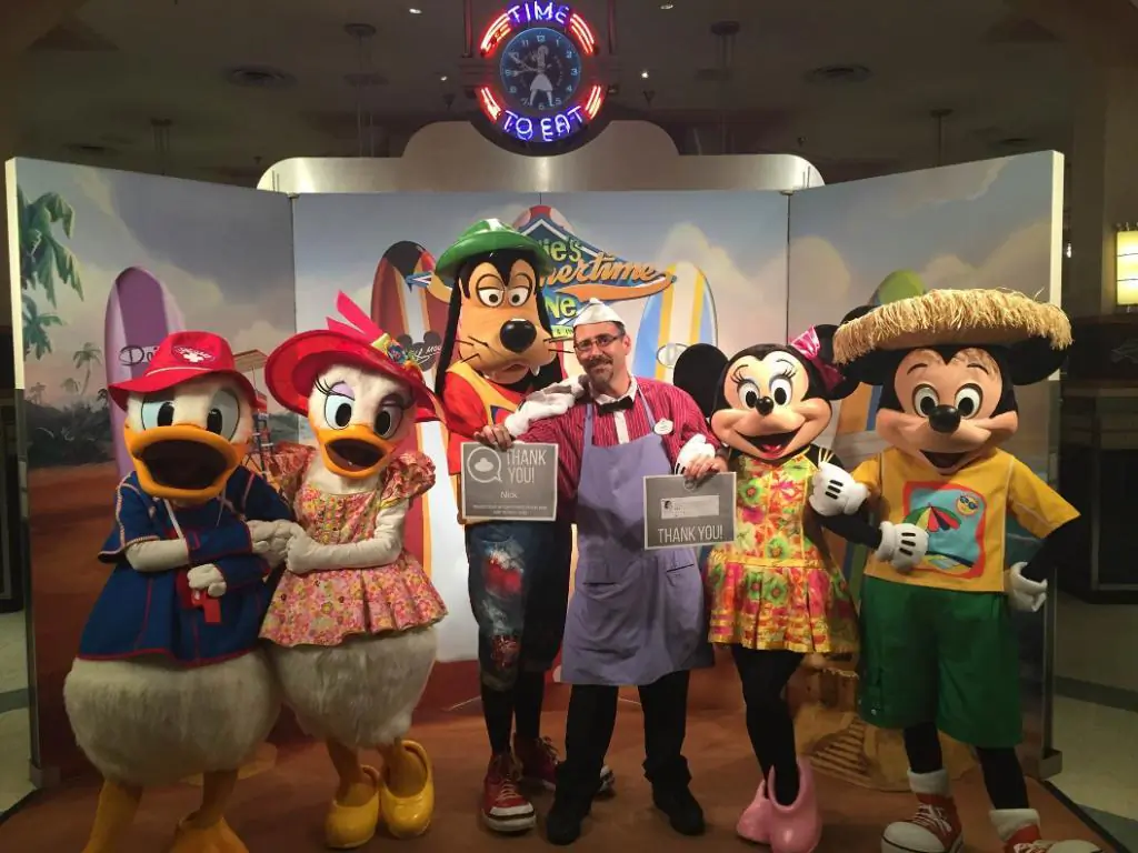 Nick Caturano, a 16-year employee at Disney World in Orlando, Fa, poses with a number of Disney characters at a recent event. (Courtesy of Nick Caturano)