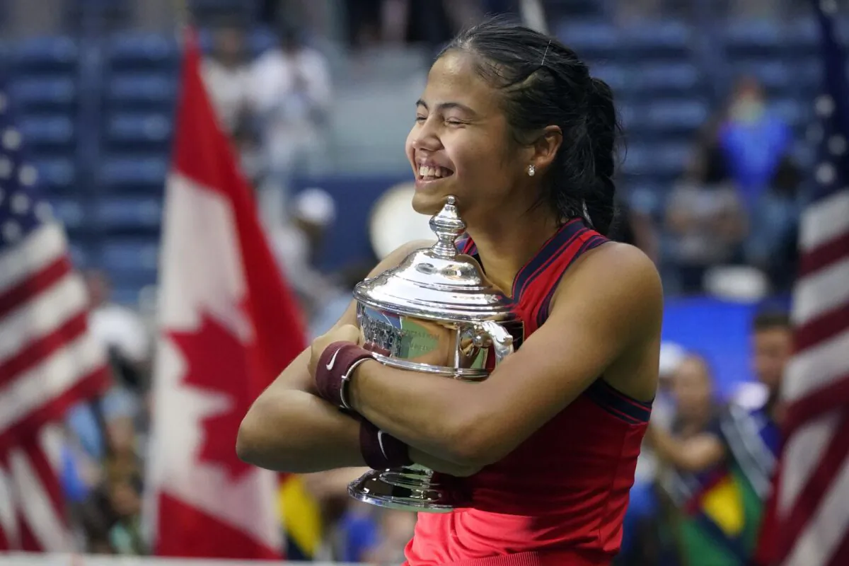 Emma Raducanu, of Britain, hugs the U.S. Open championship trophy after defeating Leylah Fernandez, of Canada, during the women's singles final of the U.S. Open tennis championships on Sept. 11, 2021, in New York. (Elise Amendola/AP Photo)